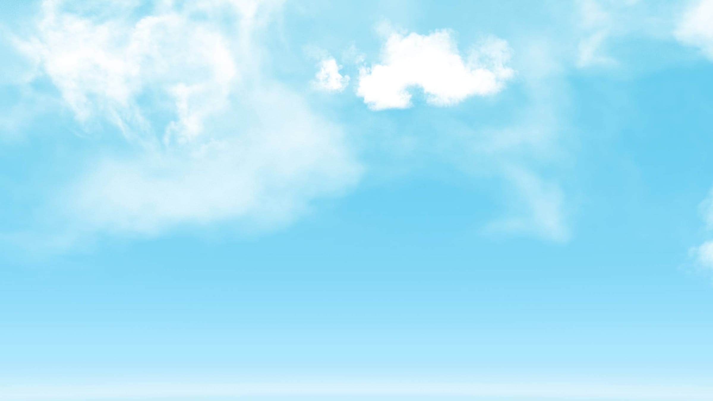 澄み渡った青空に、白くふわふわとした雲が広がっている様子。
